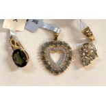 Three '9K' gold pendants:  a heart shape set alexandrite and white zircons; an oval moldavite and