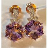 A pair of '9K' gold earrings set Wobito snowflake cut rose de France amethysts and diamonds; a
