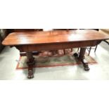 A 19th century mahogany large library table with rounded rectangular top, octagonal columns over