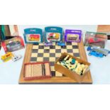 A selection of boxed and loose diecast cars; a chess set and board; an artist's easel