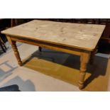 A rustic pine kitchen table with rectangular top on turned legs, length 152cm, width 90cm