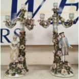 A pair of 19th century Dresden candelabra each featuring 4  male and female candle cups, marked to