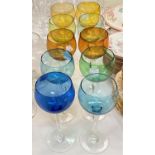 A set of 10 variously coloured tapering stem wine glasses