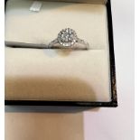 A platinum dress ring set concentric rows of diamonds with diamond chips to shoulders, total diamond
