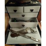 A 20th century doctor's case with an amputation saw and other surgical tools