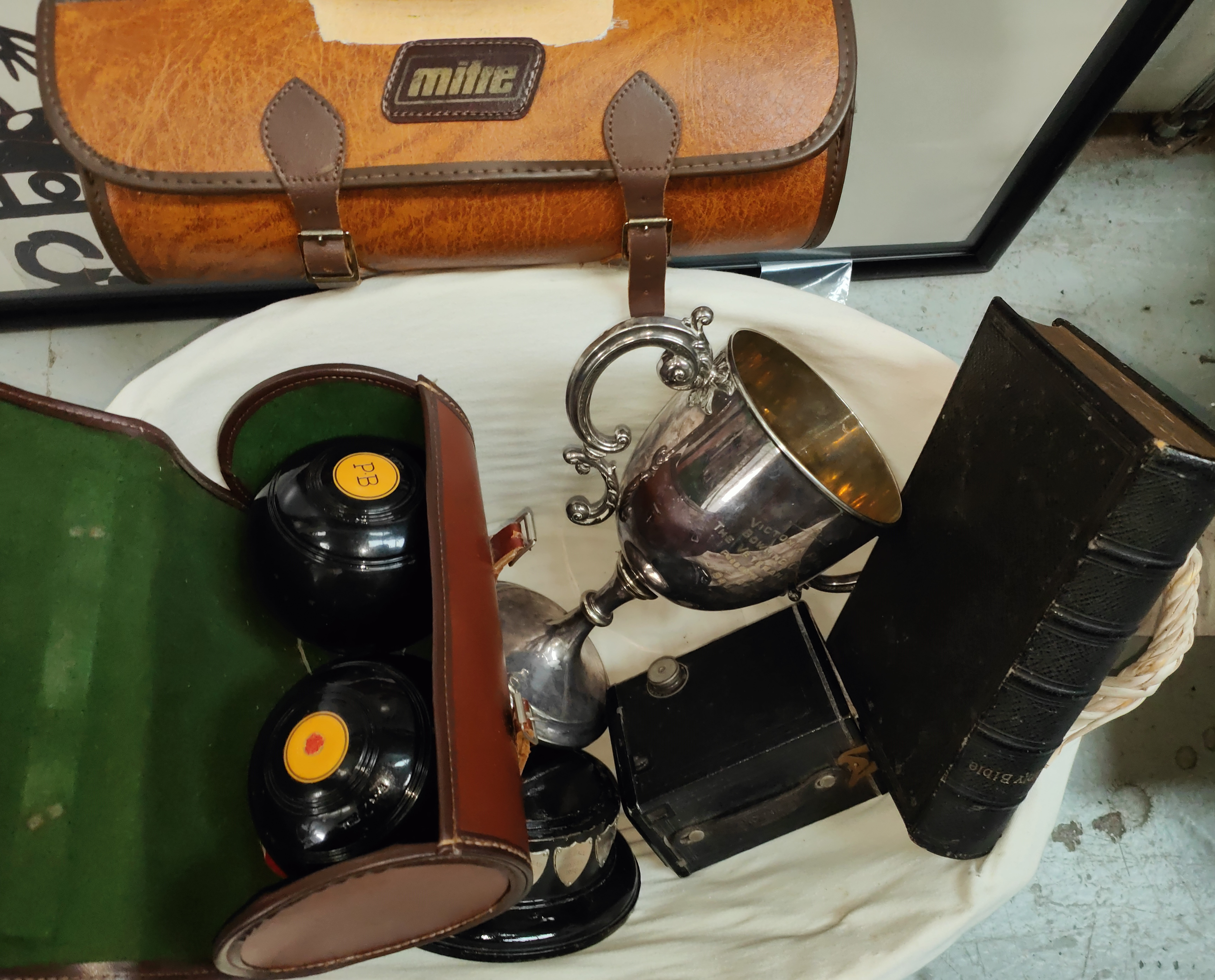A silver plated bowling trophy and two sets of bowls, a bible and cased box camera