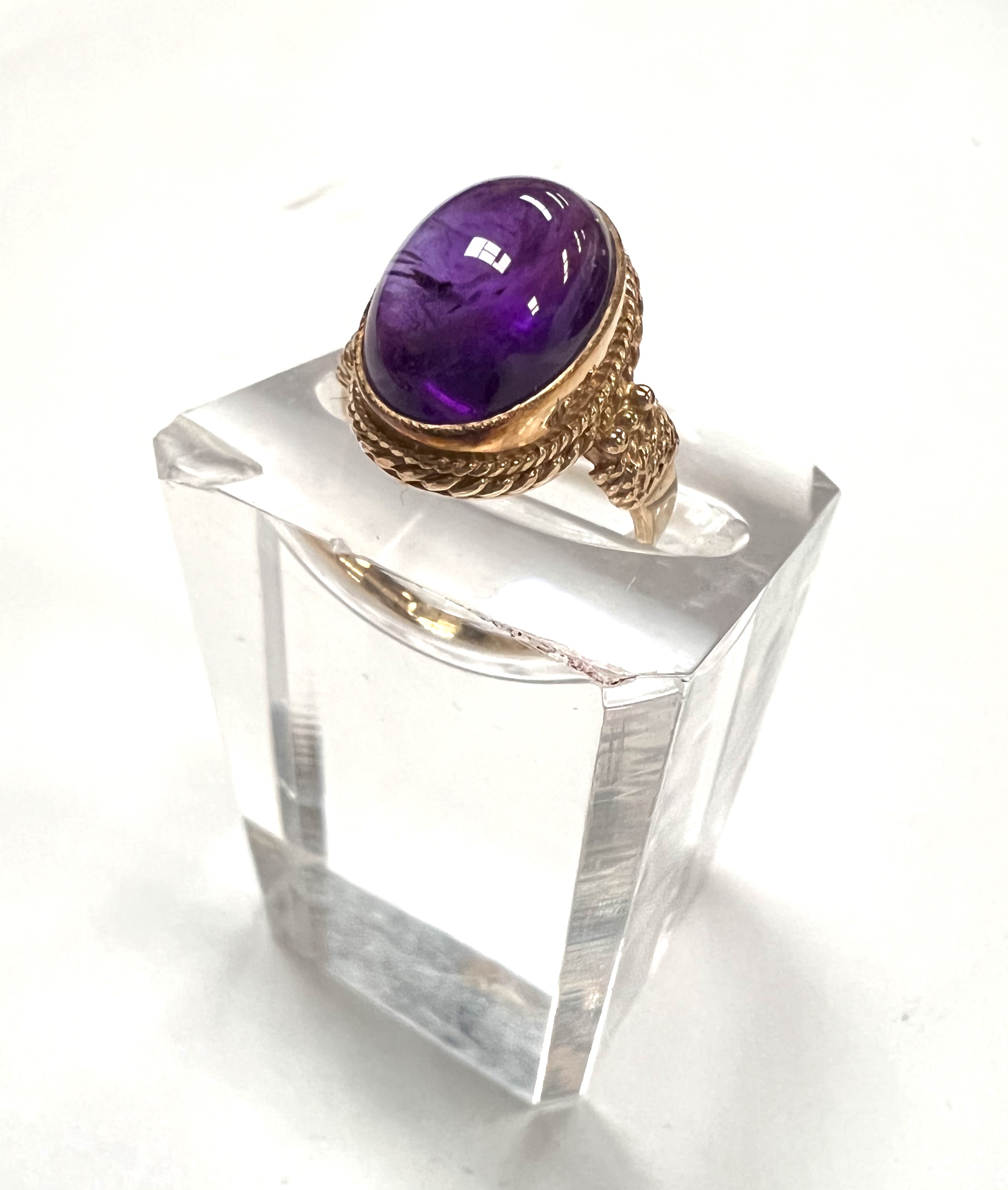 A Victorian style 9 carat hallmarked gold ring set with a large carbuncle amethyst colour stone, 4.