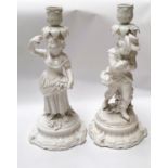 A pair of 19th century Dresden white glazed candelabra, young man and woman with grapes (some