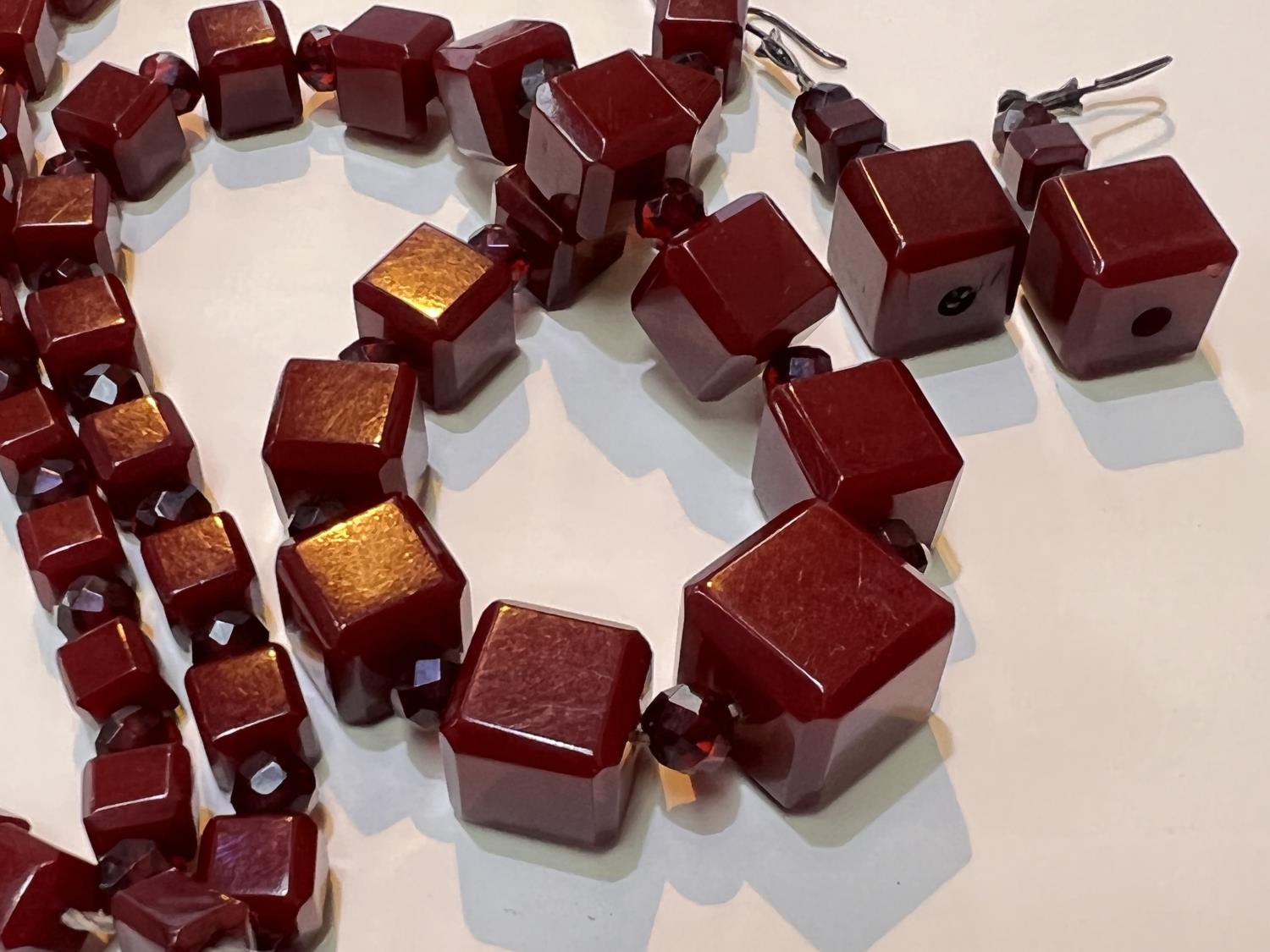 A cherry amber Bakelite necklace of graduating cube form with clear faceted beads between and a - Image 3 of 4