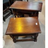 An oak hinged lid occasional table, oak magazine rack and an oak nest of tables