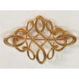 A 9 carat hallmarked gold diamond shaped brooch formed from scrolls and loops, 6.4gm