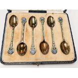A set of 6 cased hallmarked silver enamelled teaspoons with flower terminals and green stems,