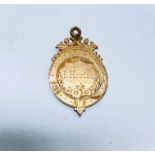 A yellow metal Victorian medal 1883, tests as approx. 9 carat, 6.2gms.