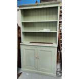 A painted pine dresser with cupboard and drawers below