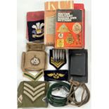 A selection of military items, badges, buttons, patches etc