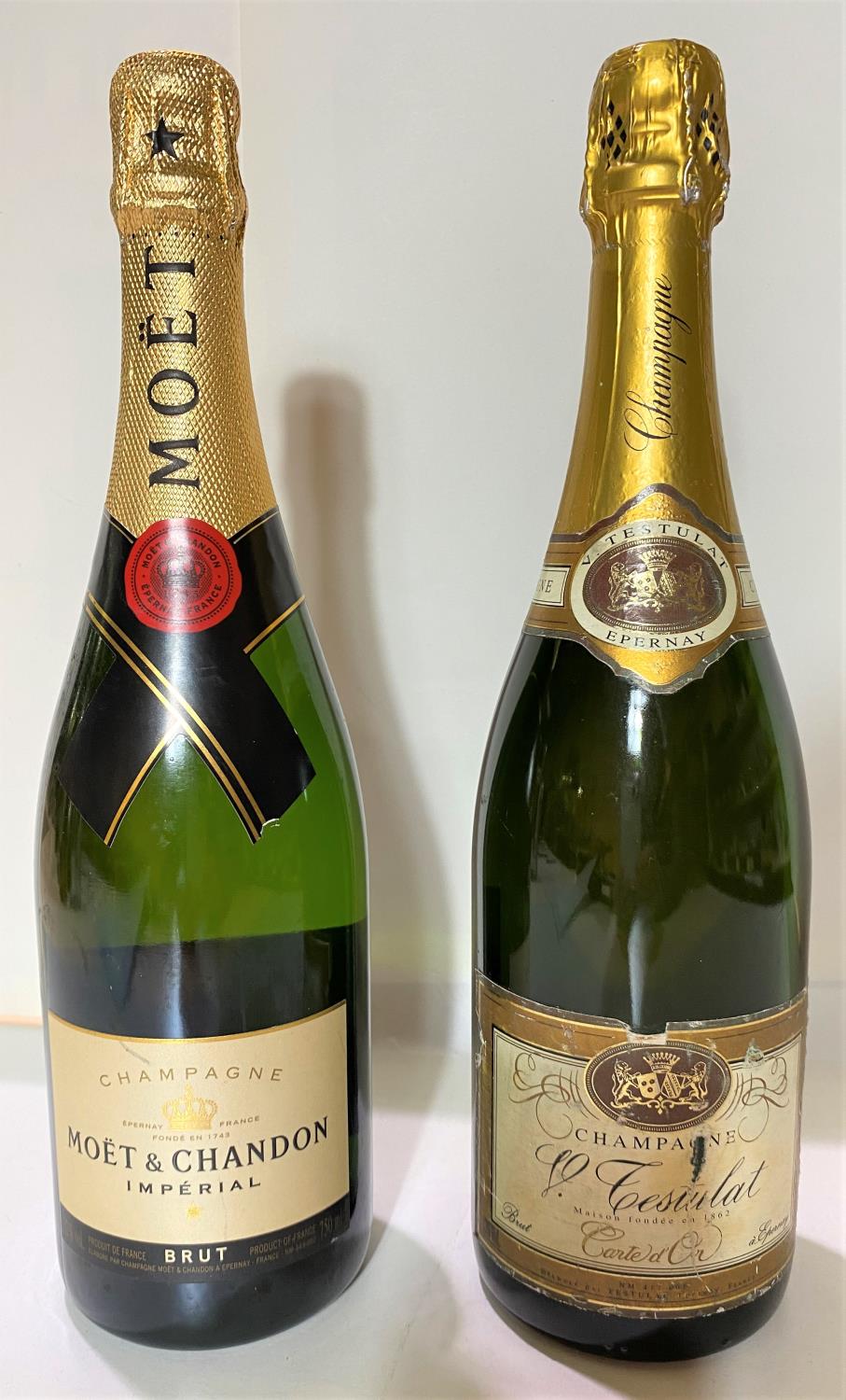 A bottle of Moet & Chandon Imperial Brut LAIXA 12% vol; s bottle of Tesulat carte d'Or Champagne
