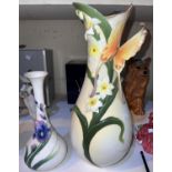 A large white porcelain vase in the Franz manner with butterfly and flowers in relief and a