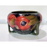 A Moorcroft circular bowl in the Art Deco style, pomegranate pattern, on 3 buttress feet,