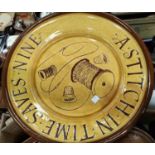 A large brown slipware dish ' a stitch  in time saves 9', pottery storage jars, etc