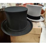 A popper top hat in black and another in grey