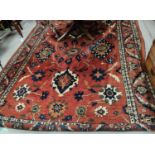 A very large rust ground carpet with floral designs etc. 3.8 meters x 2.7 meters