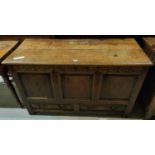 A late 18th/ early 19th century country made oak mule chest with hinged plank top, carved frieze,