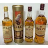 1 litre bottle Bells Scotch Whisky 8 years, 1 70cl bottle of Bells Scotch Whisky in tin; 1 bottle of