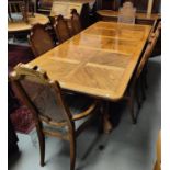 A mid 20th century oak dining suite in the American colonial style comprising extending table with