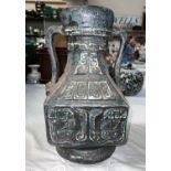 A stoneware squared vase with double handle and geometric designs.