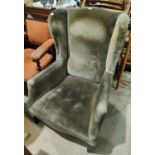 An Edwardian wingback armchair, later upholstery