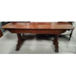 A 19th century mahogany large library table with rounded rectangular top, octagonal columns over