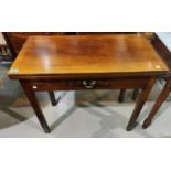 A mahogany fold over card table on square canted legs with single drawer.