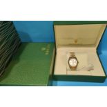 A ROLEX REPLICA watch in box and bag