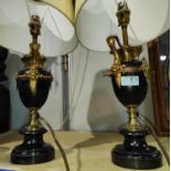 A pair of classical style urn shaped table lamps in black marble with ormolu mounts