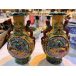 A pair of early 20th century Chinese moulded vases with Qianlong seal marks to bases with
