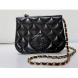 A black soft lamb leather cross body double flap bag with embossed CC logos to front and back