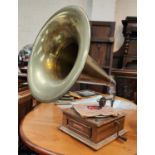 A vintage record player 'The Balmoral' with brass horn and two classic record sets.