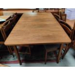 A mid 20th century Macintosh teak dining table and eight chairs of rectangular form, double fitted