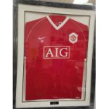 A framed and signed Manchester United 2006 - 2007 shirt, by the team with certificate on the back.
