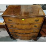 A reproduction walnut chest of 5 drawers with serpentine front