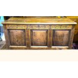 A late 18th/ early 19th century country made oak mule chest with hinged plank top, carved frieze,