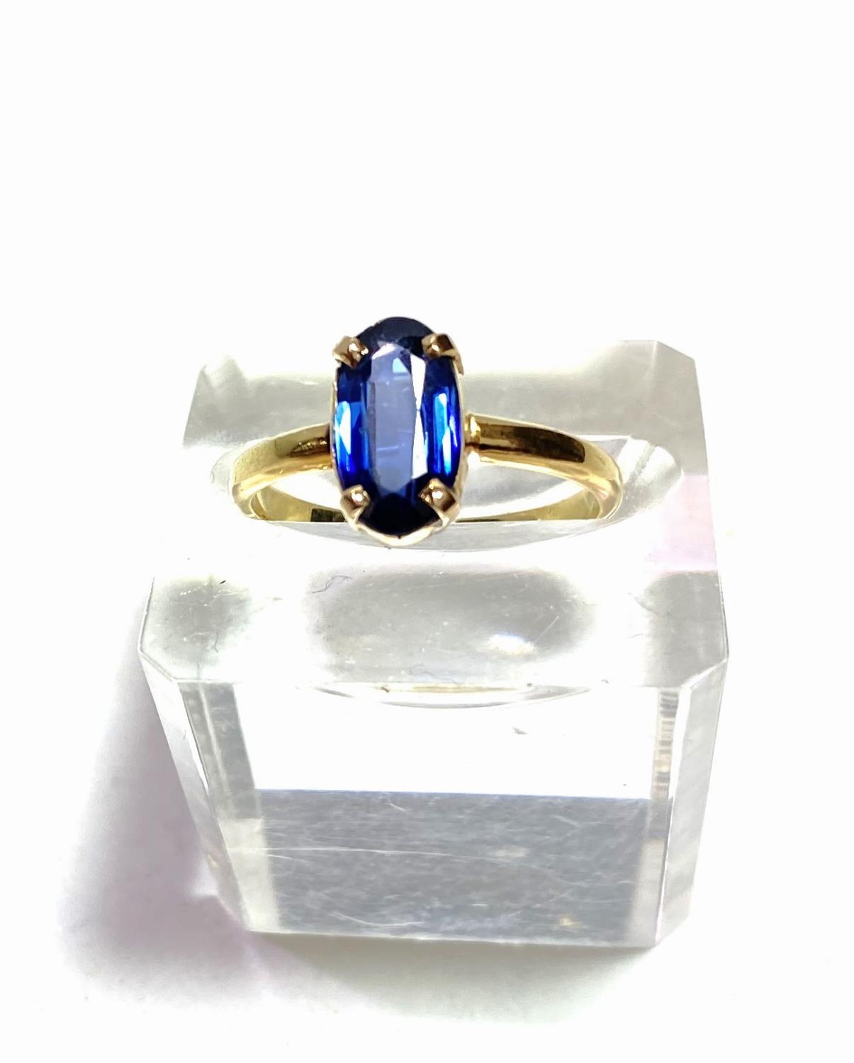 A lady's dress ring with elongated oval sapphire (11 x 6mm approx), in simple 4 claw setting, the