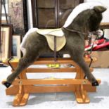 A large modern Merrythought rocking horse with saddle