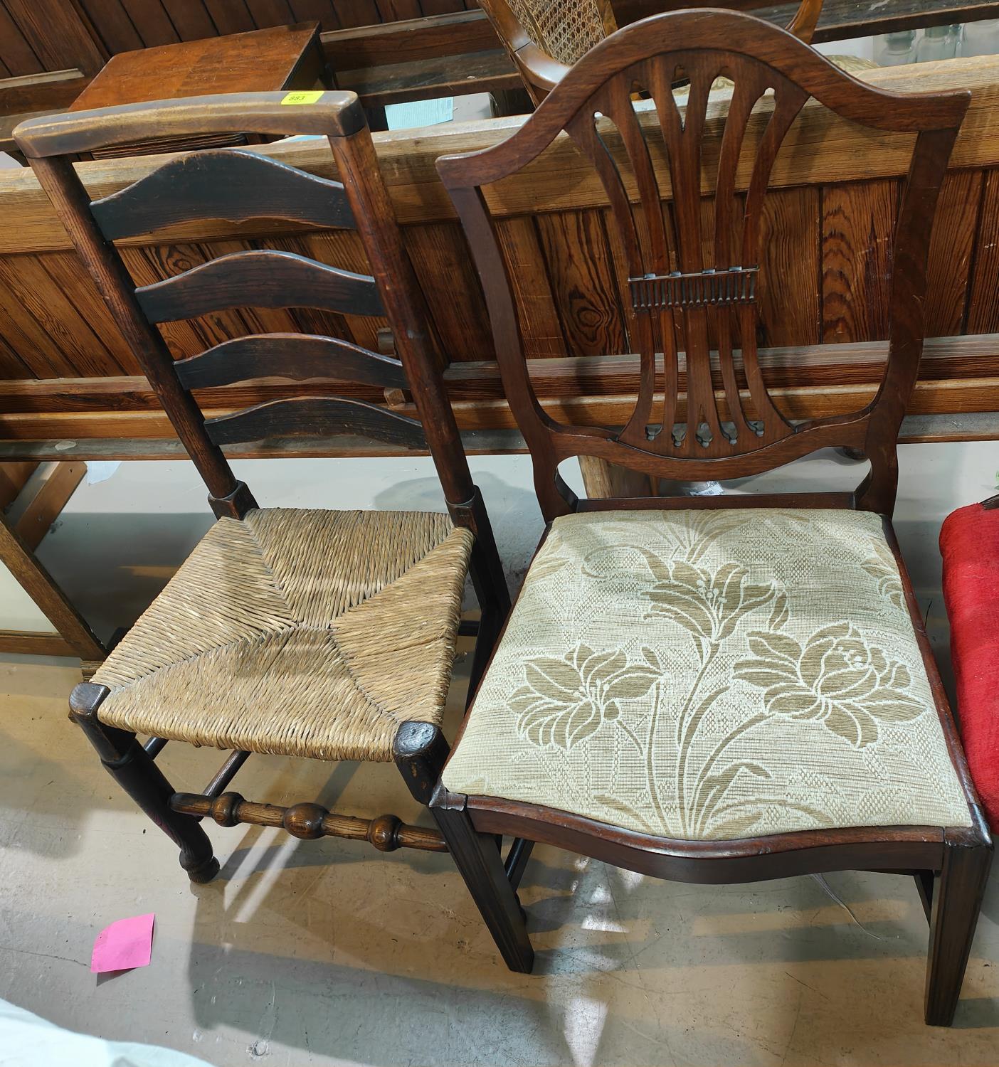 A country made ladder back rush seat chair and two mahogany Chippendale style dining chairs with