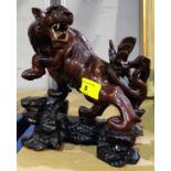 A Chinese carved hardwood lion on rocky base