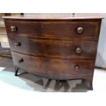 A Georgian mahogany bow front chest of three long drawers, inlaid around bracket feet length 112 x