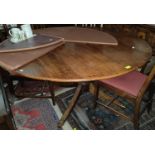 An oak period style dining table with circular top, on turned baluster column, 4 splay feet and