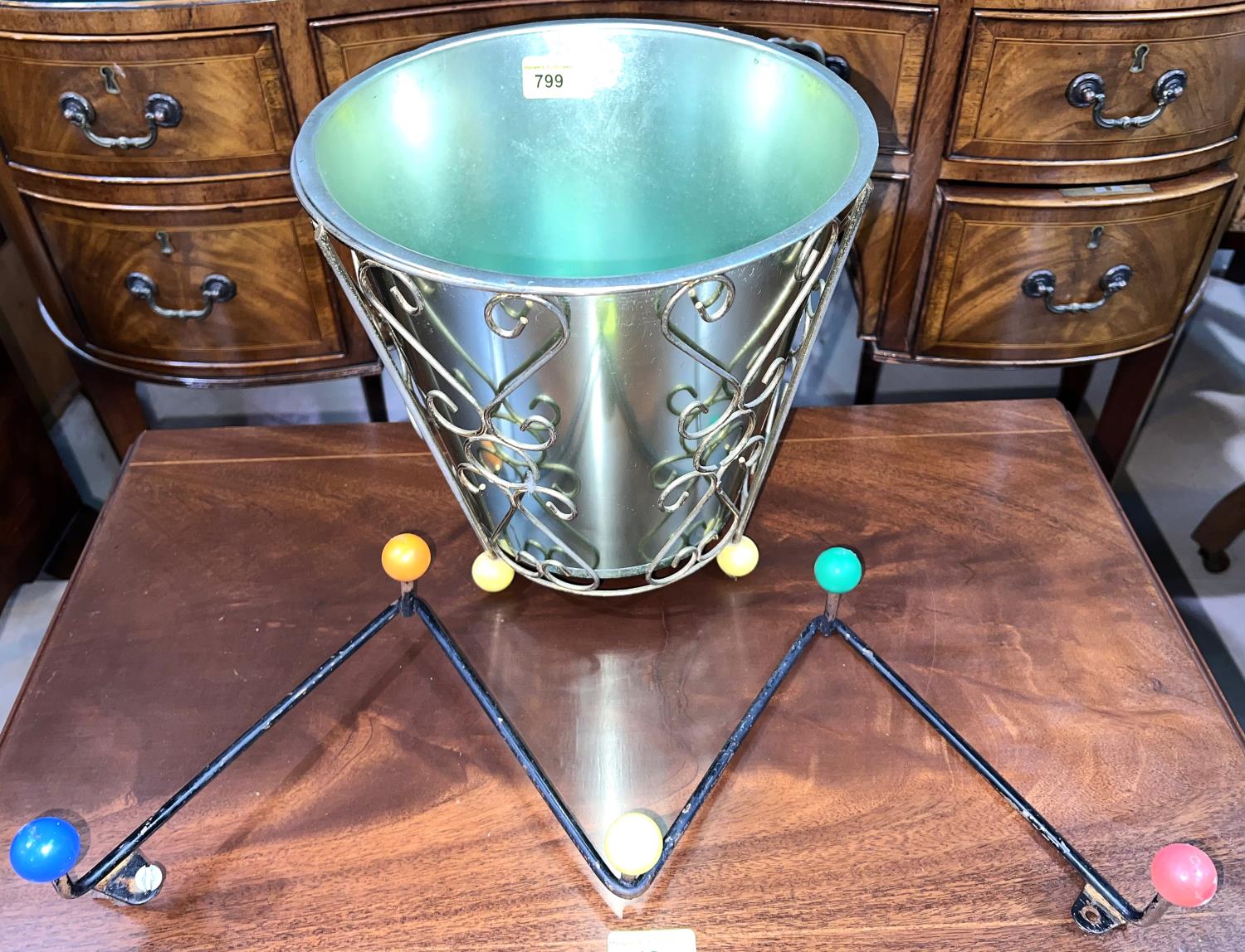 A mid 20th century wall hanging coat rack, 'Atomic' design; a wastebin