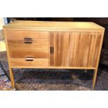A 1970's lightwood side cabinet with tambour front and 4 drawers (1 handle a.f.)