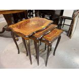 A nest of inlaid marquetry tables; a low table with circular veneered top